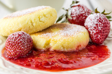 cheese pancakes with berries and powdered sugar, flowers, healthy breakfast