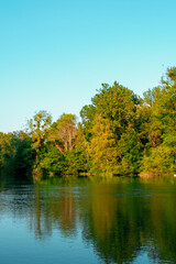 Fototapeta na wymiar Reflection of trees on lake in the Garden of Pourtalès