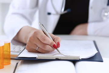 Female doctor hand hold silver pen