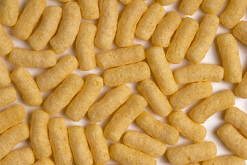 Scattered corn sticks on a light background. Background and texture.
