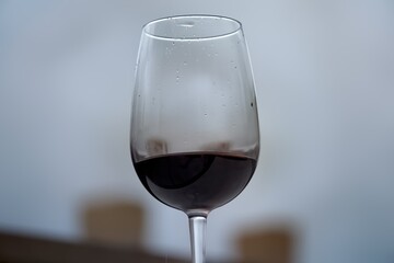 Glass of wine, which is enjoying its color and flavor. Selective focus. Wellbeing and pleasure concept.