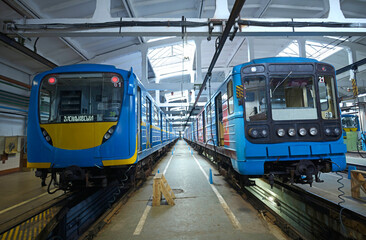 At the maintenance hall: subway trains parked on pits for technical inspection