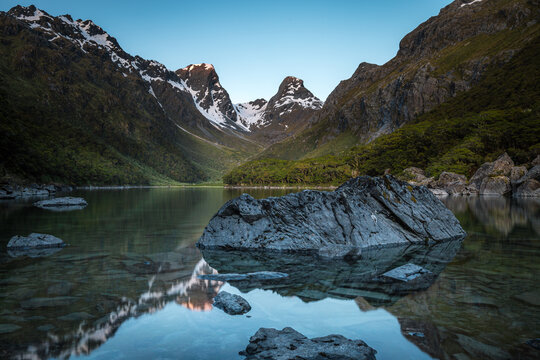Emily peak reflecting in McKenzie lake at sunset, Routeburn track, South Island, New Zealand