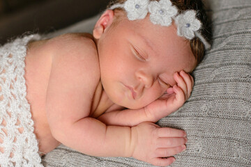 A little newborn girl eight days old. Close-up beautiful sleeping baby girl