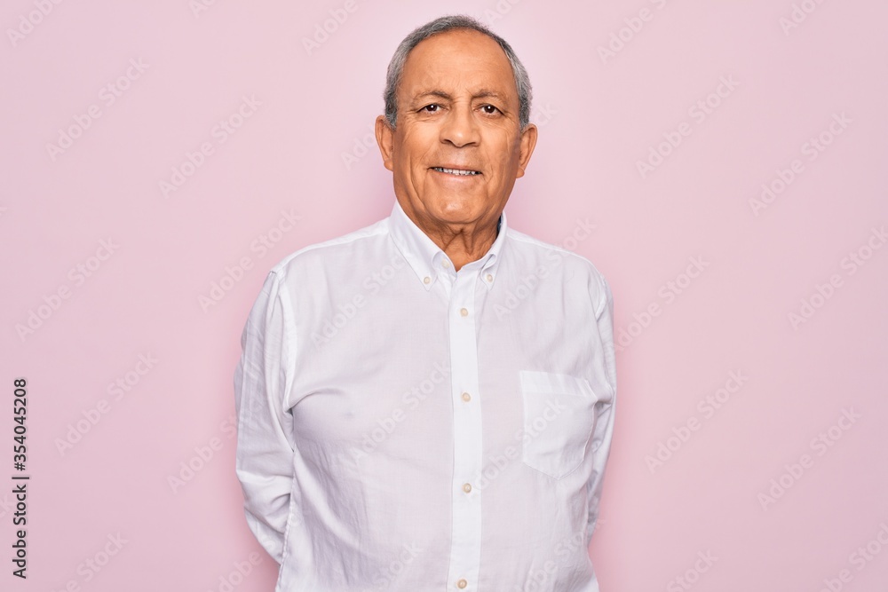 Sticker Senior handsome grey-haired man wearing elegant shirt over isolated pink background with a happy and cool smile on face. Lucky person.