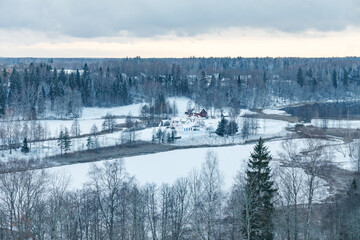 Aerial view on snowy countryside with village houses. Estonia.