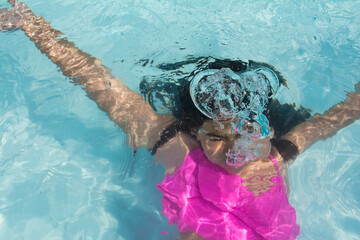 Girl underwater in a pool. Girl diving in the pool. Lifestyle