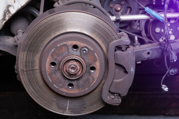 Close-up metal disk in blue backlight - main element of brake system. Friction surface for brake...