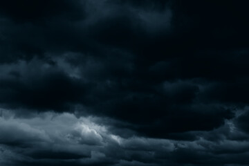 Obraz premium Stormy rain big fluffy clouds. Dark sky. Natural scenic abstract background. Weather changes backdrop. Sky filled with voluminous clouds.