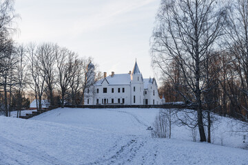 Neo gothic Alatskivi castle at winter. White building and white snow around.