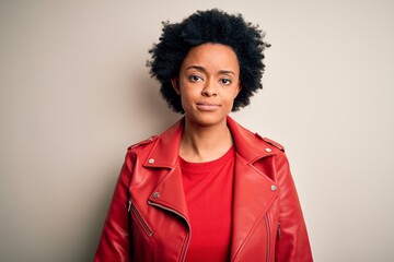 Obraz na płótnie Canvas Young beautiful African American afro woman with curly hair wearing casual red jacket Relaxed with serious expression on face. Simple and natural looking at the camera.