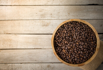 Coffee background. A roasted coffee beans  on a wooden background.