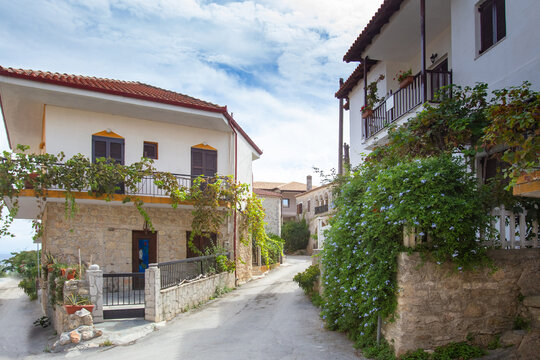 Greece. Narrow streets in the Greek city. A small town on the shores of the Mediterranean. Rest in the resort town. Greek landscape on the background of blue sky. Tourism. Greek city architecture