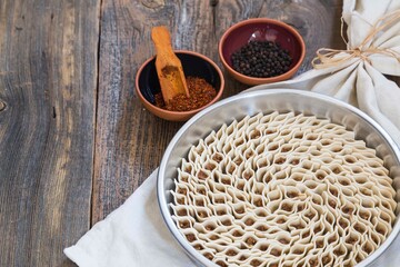 
traditional kayseri tray ravioli with pepper on wooden background. turkish food .