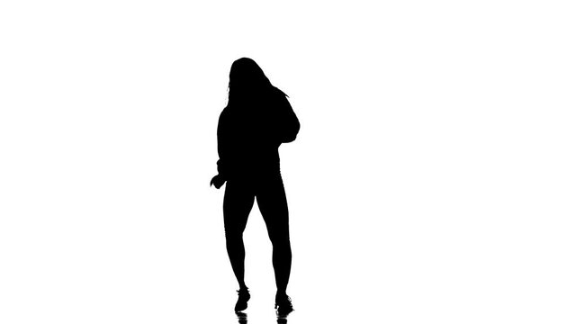 Attractive girl modern style dancer performing. Black silhouette on a white background. Contemporary choreography. Long shot.