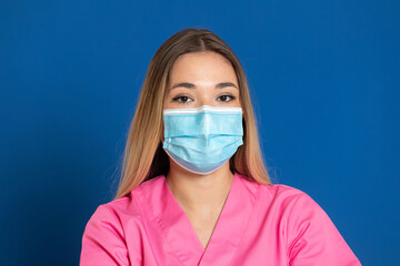 Young doctor wearing a mask face and a pink uniform