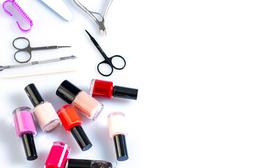 Obraz premium materials for nail care, varnishes and devices on a white table. Manicure at home