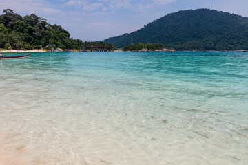 Beautiful tropical beach with white sand, palms and turquoise water on Perhentian Island, Malaysia
