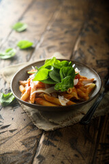 Pasta with tomato sauce and fresh spinach