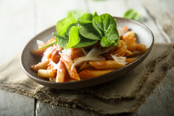Pasta with tomato sauce and fresh spinach