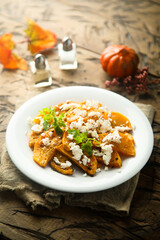 Roasted pumpkin with spices and fresh cheese