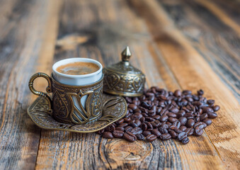 Turkish coffee in traditional copper cup on wooden background. .