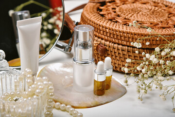 Dressing table with luxury cosmetic and skincare set, Cosmetic bottle containers with marine pearl extraction essence, Blank label for organic branding mock-up, Natural beauty product.