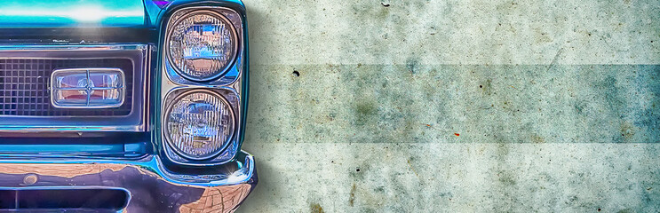 Headlight of an old beautiful dark blue car on a concrete wall background. Copy space concept for...