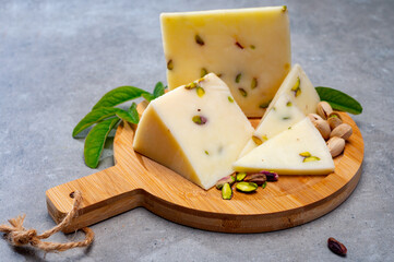 Cheese collection, fresh Italian pecorino cheese made from sheep milk filled with pistachio nuts from Bronte, Sicily