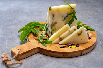 Cheese collection, fresh Italian pecorino cheese made from sheep milk filled with pistachio nuts...