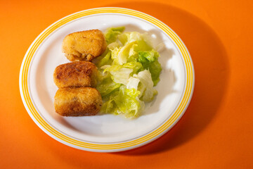 Plate with tasty chicken croquettes on the table