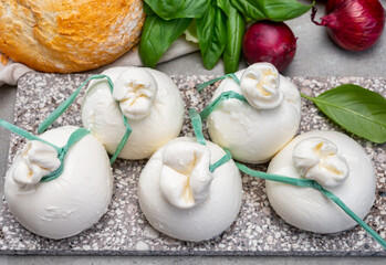 Cheese collection, fresh soft Italian cheese from Puglia, white balls of burrata or burratina cheese made from mozzarella and cream filling