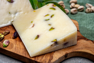 Cheese collection, fresh Italian pecorino cheese made from sheep milk filled with pistachio nuts from Bronte, Sicily
