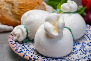 Cheese collection, fresh soft Italian cheese from Puglia, white balls of burrata or burratina cheese made from mozzarella and cream filling