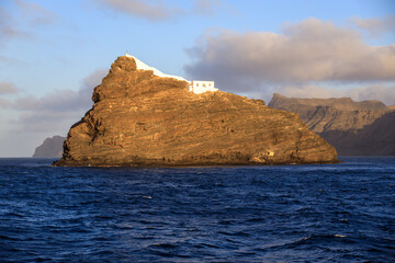 Ilhéu dos Pássaros islet in the bay of Mindelo, Sao Vicente Island, Cape Verde with a lighthouse seen from a ferry