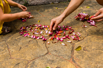Girls playing wiht petals of flowers in Botanical gardens, Kuala Lumpur, Malaysia