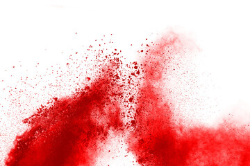 Freeze motion of red powder exploding, isolated on white background. Abstract design of red dust...