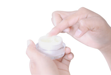 Closeup woman hand applying cream or moisturizer from box isolated on white background, selective focus