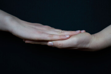 Isolated woman hand closeup making gestures on black background