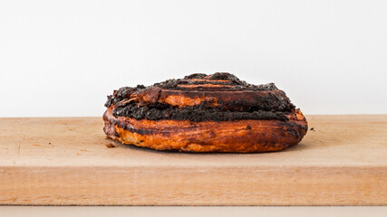 A Hungarian pastry called cocoa roll (kakós csiga) on a wooden cutting board.