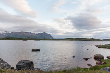 Beautiful view of the Norwegian fjords with turquoise water surrounded by cloudy sky, selective focus