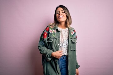 Young beautiful woman wearing fashion urban clothes, model wearing casual street style standing over pink background