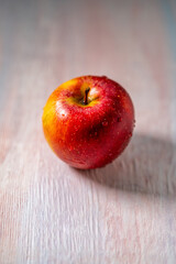 apple on a wooden pink background