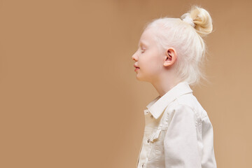 side view on strange little caucasian girl with unusual appearance, she has pale skin and white hair, alien concept. natural beauty, people diversity - obrazy, fototapety, plakaty