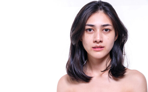 Beautiful young woman without make up on her face no retouch, fresh face while looking at camera on isolated white background. Facial treatment, cosmetic, spa, make up, beauty surgery clinic concept.