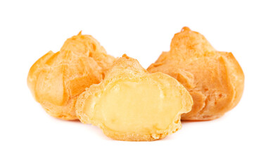 Homemade profiteroles with cream,isolated on a white background. Fresh baked golden profiterole. Custard cake.