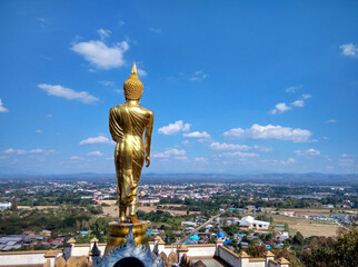 Fototapeta na wymiar The Buddha turned his back Looking at the city with clear sky