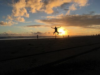 Golden Sunset in a tropical beach With sand, Horse and rock