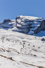 Fototapeta na wymiar Dolomites Alps mountains in spring with cable car in Italy, Madonna di Campiglio TN
