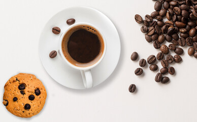 Cookie,a cup of coffee, roasted coffee beans are placed in an isolated background. 